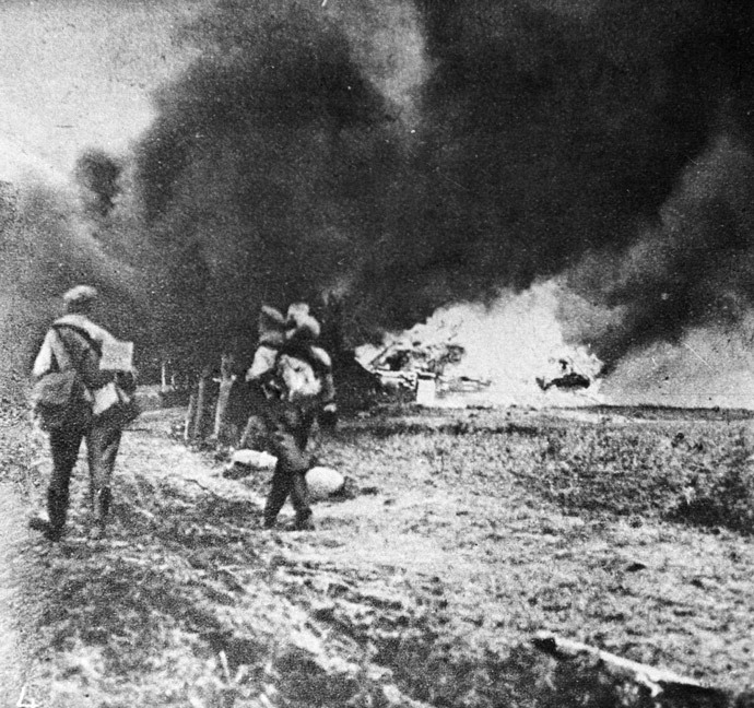 Soldiers leave burning village.jpg