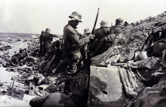 24.7a German soldiers in a trench firing into the flank of a French assault