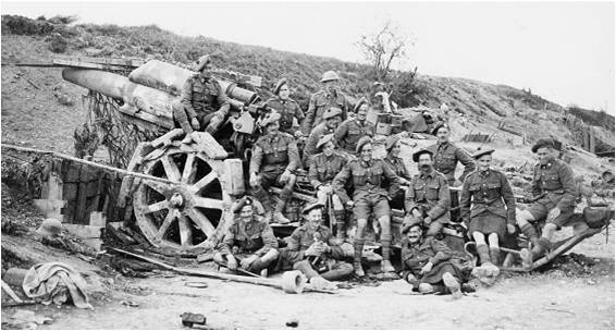 8.8a Men of the 15th Battalion posing with a captured German. artillery